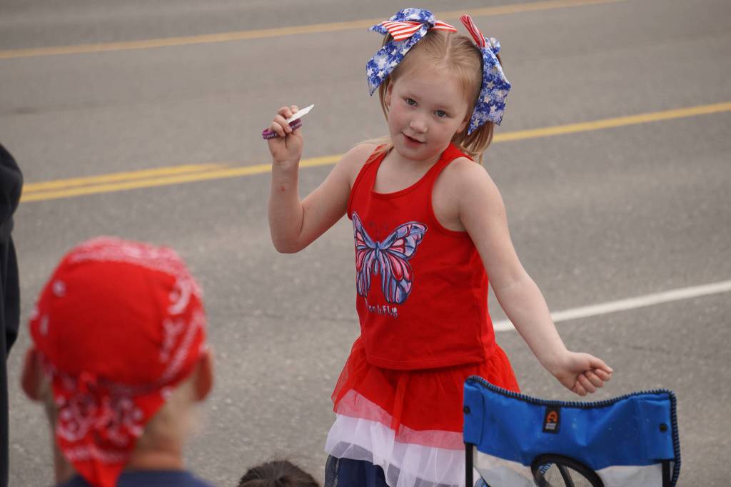 A young girl dances along to a routine by Diamond Dance Project as the Fourth of July Parade moves down the Kenai Spur Highway in Kenai, Alaska on Tuesday, July 4, 2023. (Jake Dye/Peninsula Clarion)