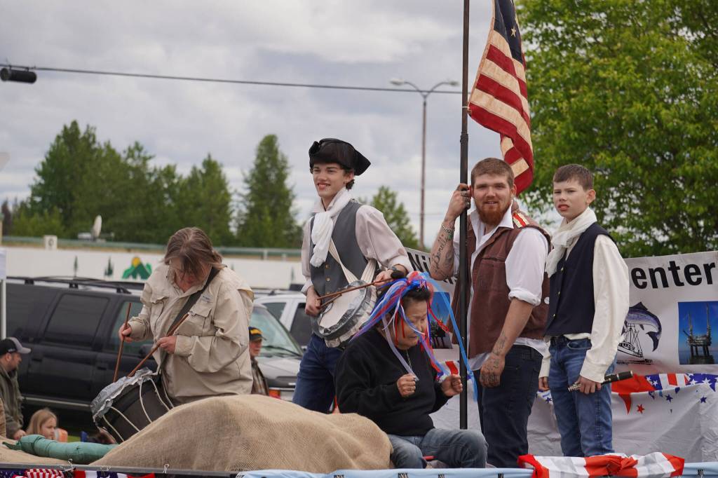 Representatives of the Nikiski Senior Center smile and wave as the Fourth of July Parade moves down the Kenai Spur Highway in Kenai, Alaska on Tuesday, July 4, 2023. (Jake Dye/Peninsula Clarion)