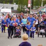 The Boys & Girls Clubs of the Kenai Peninsula smile and wave as the Fourth of July Parade moves down the Kenai Spur Highway in Kenai, Alaska on Tuesday, July 4, 2023. (Jake Dye/Peninsula Clarion)