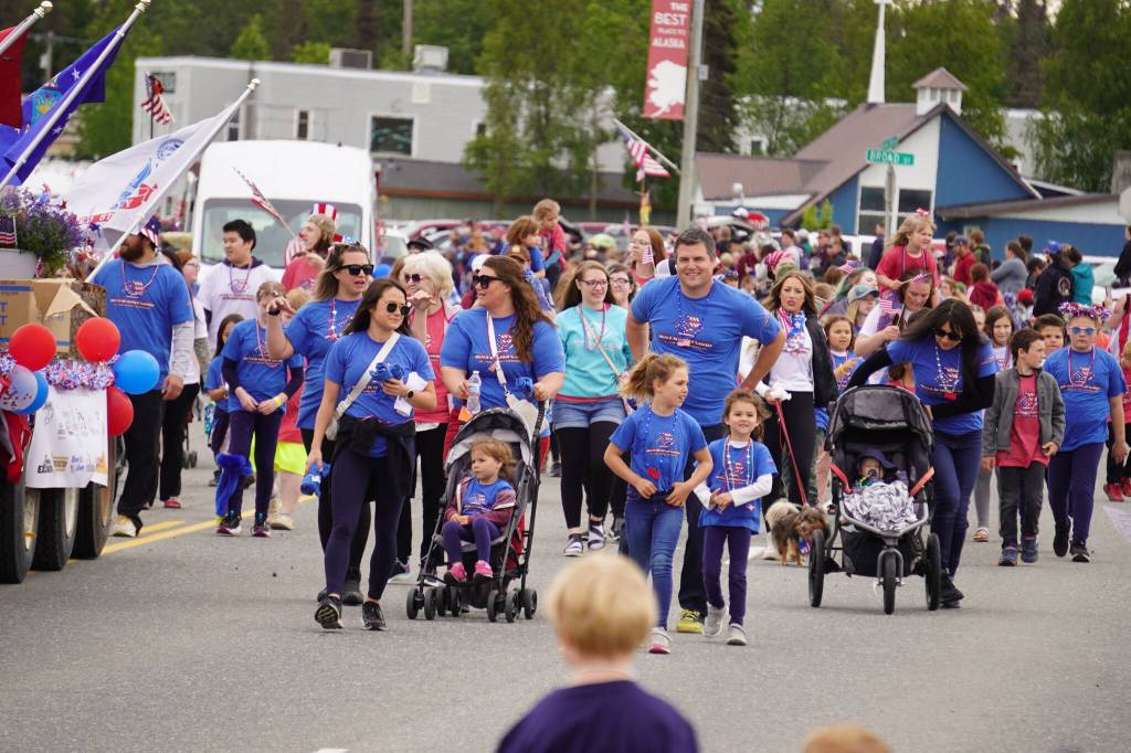 The Boys & Girls Clubs of the Kenai Peninsula smile and wave as the Fourth of July Parade moves down the Kenai Spur Highway in Kenai, Alaska on Tuesday, July 4, 2023. (Jake Dye/Peninsula Clarion)