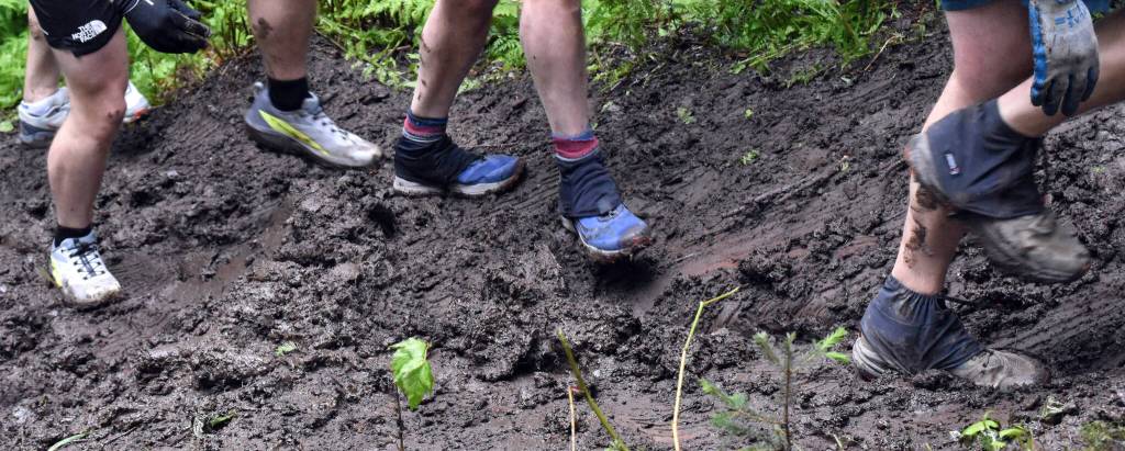 Racers climb in mud during the mens Mount Marathon Race on Tuesday, July 4, 2023, in Seward, Alaska. (Photo by Jeff Helminiak/Peninsula Clarion)