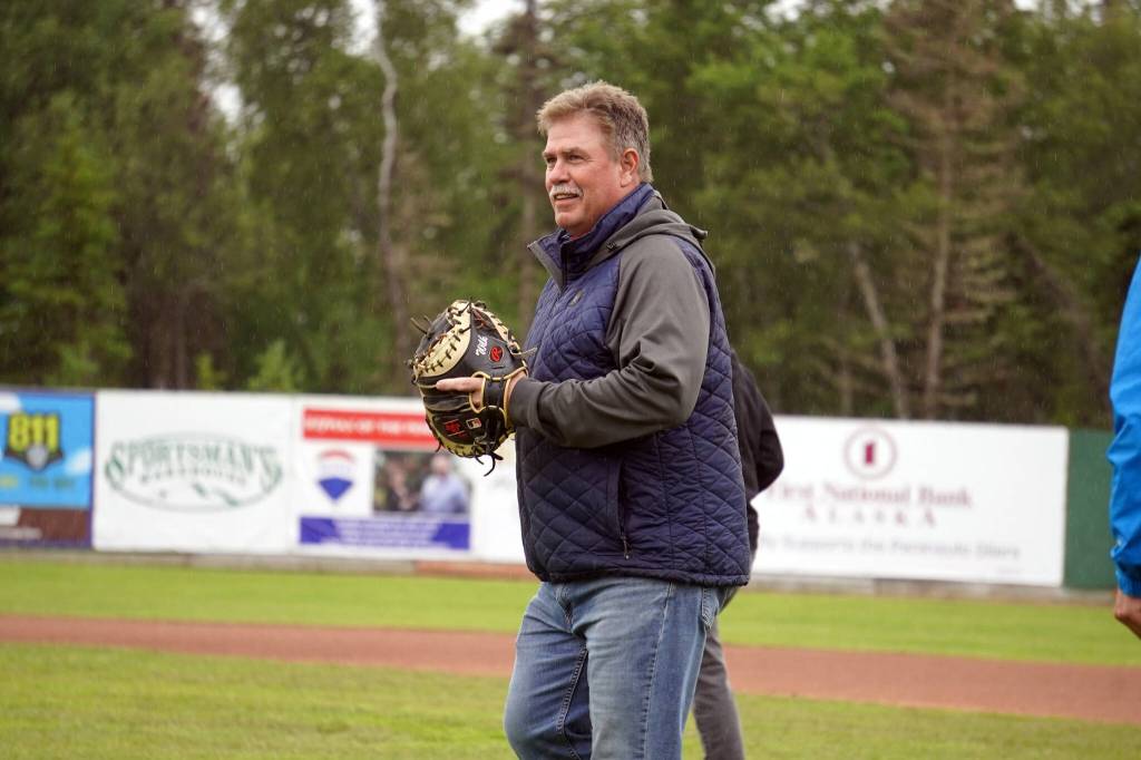 Brian Gabriel, mayor of Kenai, readies to catch the ceremonial first pitch before a game between the Peninsula Oilers and the Mat-Su Miners on Tuesday, July 4, 2023, at Coral Seymour Memorial Park in Kenai, Alaska. (Jake Dye/Peninsula Clarion)