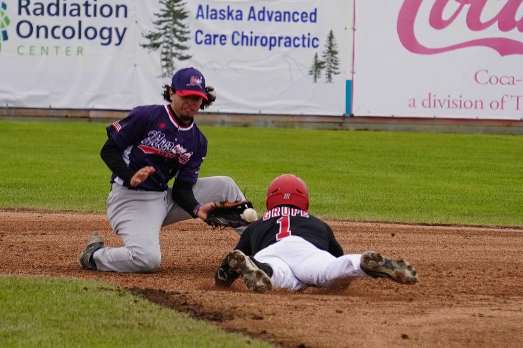 Brett Grupe dives into second base while Emilio Barreras brings in the ball for a tag during a game between the Peninsula Oilers and the Mat-Su Miners on Tuesday, July 4, 2023, at Coral Seymour Memorial Park in Kenai, Alaska. (Jake Dye/Peninsula Clarion)