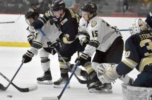 Janesville (Wisconsin) Jets forward Jaden Johnson, Kenai River Brown Bears forward Bryce Monrean, Janesville forward Parker Mabbett and Kenai River forward Hunter Newhouse battle for the puck in front of Janesville goalie Peter Sterling on Saturday, Feb. 25, 2023, at the Soldotna Regional Sports Complex in Soldotna, Alaska. (Photo by Jeff Helminiak/Peninsula Clarion)