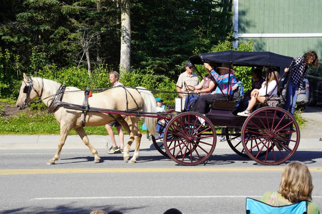 A horse and carriage proceed down Binkley Avenue in Soldotna, Alaska, part of the Progress Days Parade on Saturday, July 22, 2023. (Jake Dye/Peninsula Clarion)
