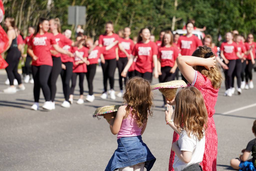 Kids watch as Forever Dance performers proceed down Binkley Avenue in Soldotna, Alaska, part of the Progress Days Parade on Saturday, July 22, 2023. (Jake Dye/Peninsula Clarion)