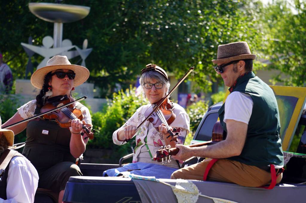 Members of the Treefort Theatre play music from the back of a truck as they proceed down Binkley Avenue in Soldotna, Alaska, part of the Progress Days Parade on Saturday, July 22, 2023. (Jake Dye/Peninsula Clarion)