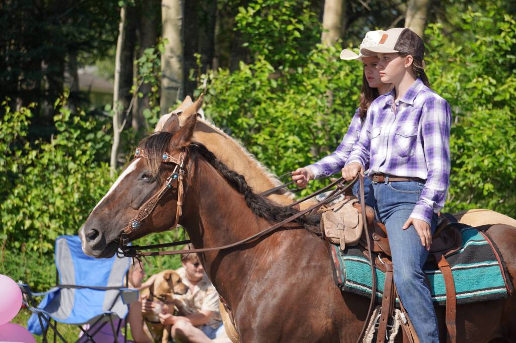 Horseriders proceed down Binkley Avenue in Soldotna, Alaska, part of the Progress Days Parade on Saturday, July 22, 2023. (Jake Dye/Peninsula Clarion)
