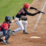 Owen McElfatrick of the Peninsula Oilers bunts for a base hit against the Chugiak-Eagle River Chinooks on Thursday, July 27, 2023, at Coral Seymour Memorial Park in Kenai, Alaska. (Photo by Jeff Helminiak/Peninsula Clarion)