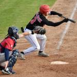 Owen McElfatrick of the Peninsula Oilers bunts for a base hit against the Chugiak-Eagle River Chinooks on Thursday, July 27, 2023, at Coral Seymour Memorial Park in Kenai, Alaska. (Photo by Jeff Helminiak/Peninsula Clarion)