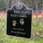 A sign identifies a space for larger dogs at the Kenai Bark Park in Kenai, Alaska, on Friday, July 28, 2023. (Jake Dye/Peninsula Clarion)