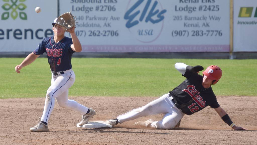 Michael Elko of the Peninsula Oilers beats a throw to Chugiak-Eagle River Chinooks second baseman Kevin Duran on Sunday, July 30, 2023, at Coral Seymour Memorial Park in Kenai, Alaska. (Photo by Jeff Helminiak/Peninsula Clarion)