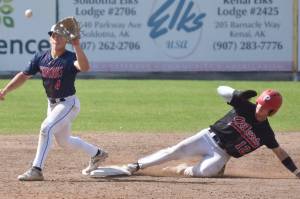 Michael Elko of the Peninsula Oilers beats a throw to Chugiak-Eagle River Chinooks second baseman Kevin Duran on Sunday, July 30, 2023, at Coral Seymour Memorial Park in Kenai, Alaska. (Photo by Jeff Helminiak/Peninsula Clarion)