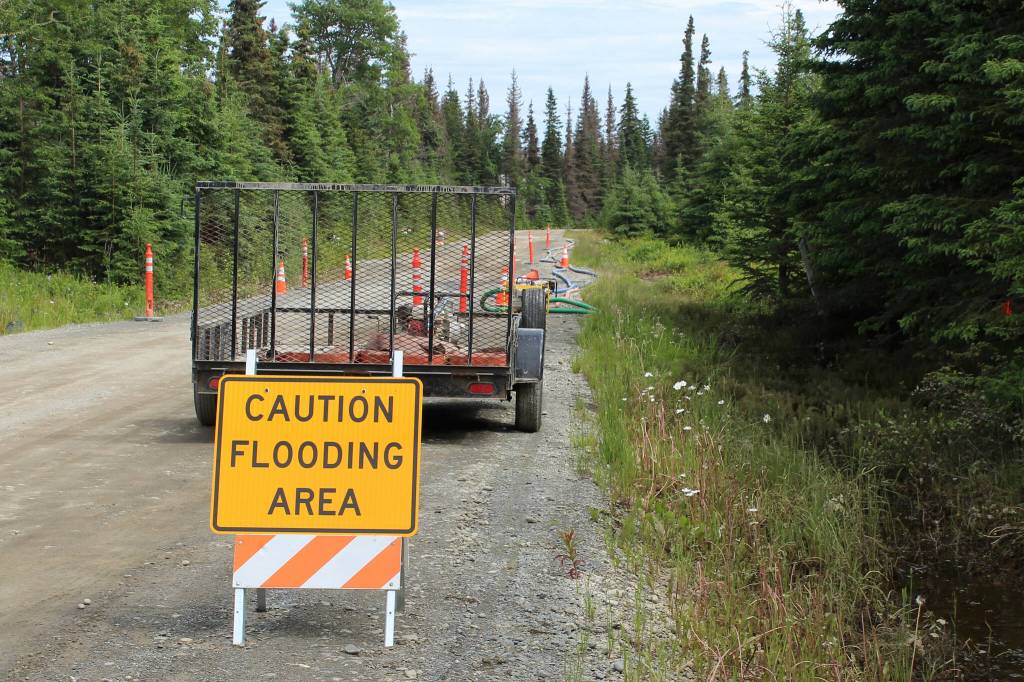 A sign cautions motorists of flood hazards along Patrick Dr. off on Friday, July 21, 2023 near Kenai, Alaska. (Ashlyn OHara/Peninsula Clarion)