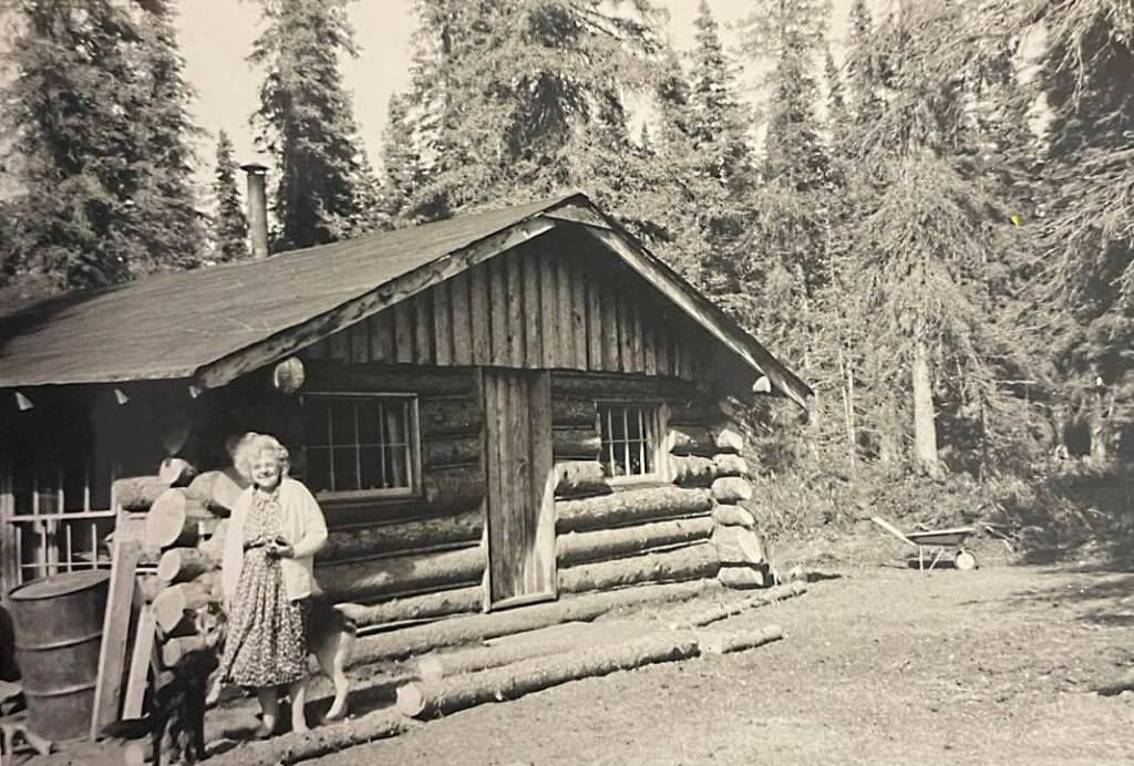 Amanda Walker, of Kenai, poses in front of her friend Mable Smiths homestead cabin off Kalifornsky Beach Road, circa 1961. (photo courtesy of the Smith Family Collection)