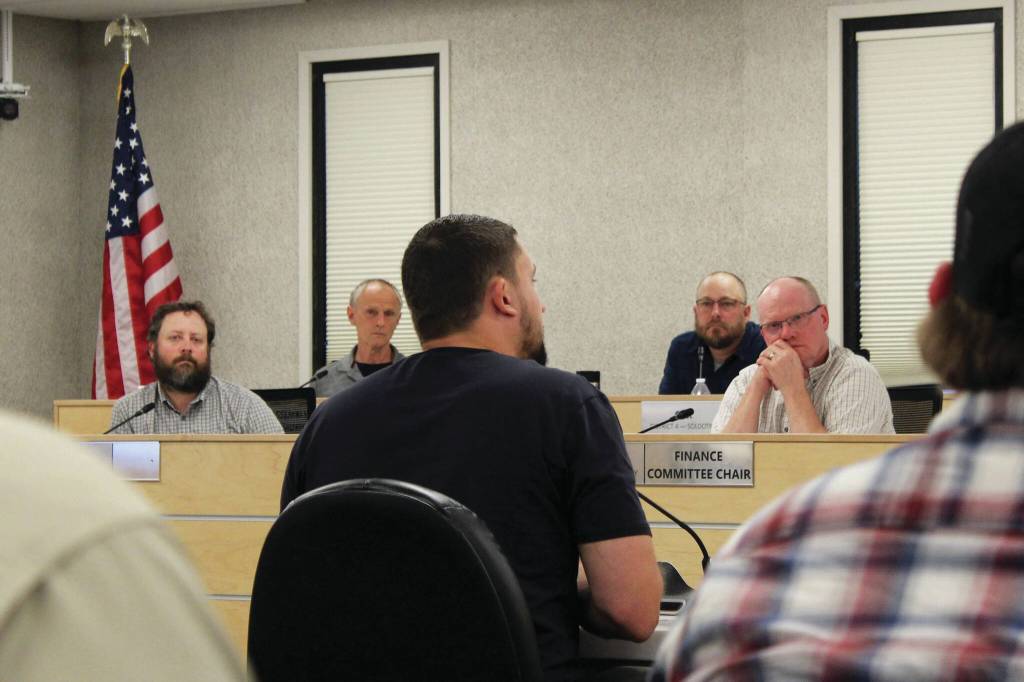 Outlaw Body and Paints Wesley Jackson (center) testifies before the Kenai Peninsula Borough Assembly about the affects of calcium chloride brine on vehicles he treats during a meeting on Tuesday in Soldotna. (Ashlyn OHara/Peninsula Clarion)