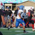 Kenais Bobby Hayes runs with the ball, closely pursued by Kodiaks Jet Jered Mendoza during a season opening game at Ed Hollier Field in Kenai, Alaska, on Friday, Aug. 11, 2023. (Jake Dye/Peninsula Clarion)
