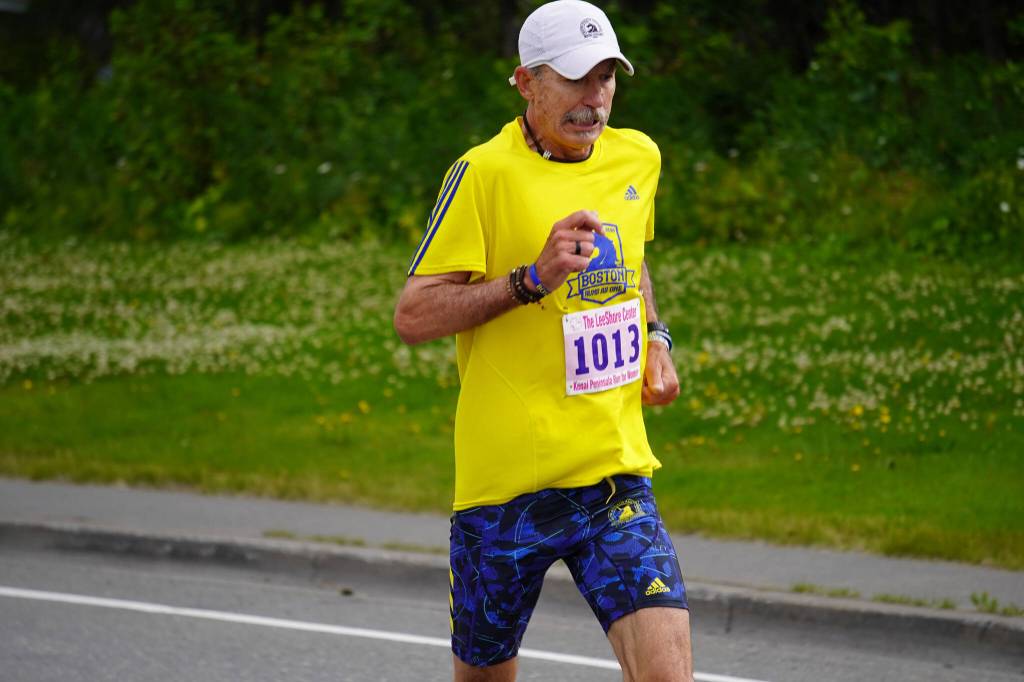Mark Barbee, first place finisher for the Mens 10K, races towards the finish chute of the 34th Annual Kenai Peninsula Violence Free Community Run in Kenai, Alaska, on Saturday, Aug. 12, 2023. (Jake Dye/Peninsula Clarion)