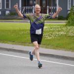 Jim White races toward the finish chute of the 34th Annual Kenai Peninsula Violence Free Community Run in Kenai, Alaska, on Saturday, Aug. 12, 2023. (Jake Dye/Peninsula Clarion)