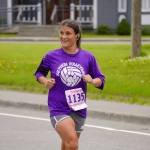 Viorica Thompson, first place finisher for the Womens 10K, races toward the finish chute of the 34th Annual Kenai Peninsula Violence Free Community Run in Kenai, Alaska, on Saturday, Aug. 12, 2023. (Jake Dye/Peninsula Clarion)