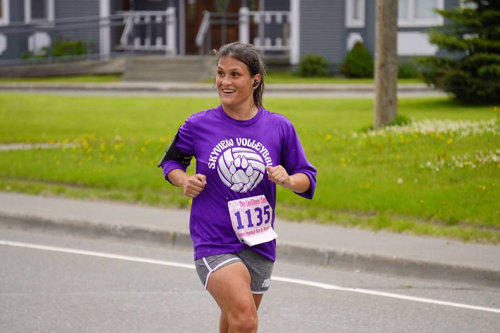 Viorica Thompson, first place finisher for the Womens 10K, races toward the finish chute of the 34th Annual Kenai Peninsula Violence Free Community Run in Kenai, Alaska, on Saturday, Aug. 12, 2023. (Jake Dye/Peninsula Clarion)