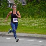 Shari BeDunnah, first place finisher for the Womens 5K, races towards the finish chute of the 34th Annual Kenai Peninsula Violence Free Community Run in Kenai, Alaska, on Saturday, Aug. 12, 2023. (Jake Dye/Peninsula Clarion)
