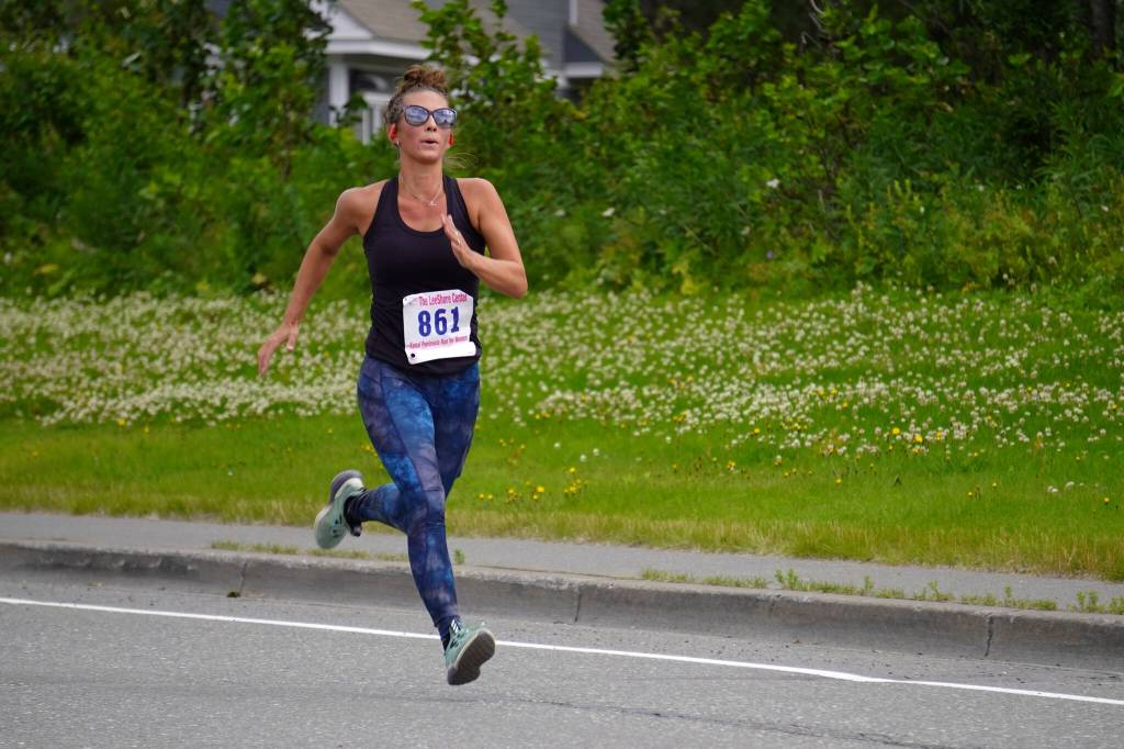 Shari BeDunnah, first place finisher for the Womens 5K, races towards the finish chute of the 34th Annual Kenai Peninsula Violence Free Community Run in Kenai, Alaska, on Saturday, Aug. 12, 2023. (Jake Dye/Peninsula Clarion)