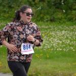 Stephanie Macias races toward the finish chute of the 34th Annual Kenai Peninsula Violence Free Community Run in Kenai, Alaska, on Saturday, Aug. 12, 2023. (Jake Dye/Peninsula Clarion)