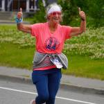 Renee Helie races towards the finish chute of the 34th Annual Kenai Peninsula Violence Free Community Run in Kenai, Alaska, on Saturday, Aug. 12, 2023. (Jake Dye/Peninsula Clarion)