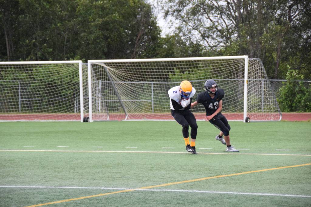 Barrows Ethan Goodwin catches a pass from teammate Dwight Unutoa and scores a touchdown fifteen seconds before the end of the final quarter, bringing the Whalers score to 12 points at the home opener varsity game on Saturday, Aug. 12, 2023 in Homer, Alaska. (Delcenia Cosman/Homer News)