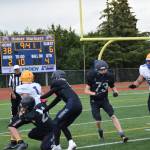 Barrows Angelo Reyes carries the ball but is tackled by Homer in the fourth quarter of the home opener game on Saturday, Aug. 12, 2023 in Homer, Alaska. (Delcenia Cosman/Homer News)