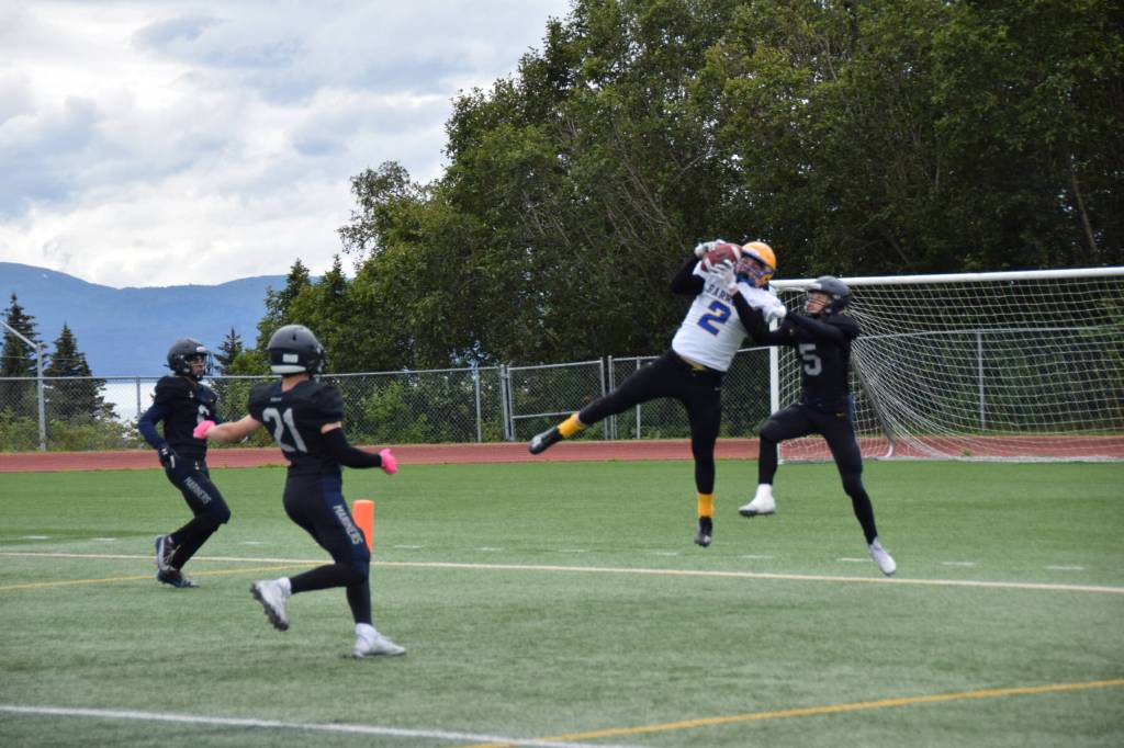 Barrows Ethan Goodwin catches a pass from Dwight Unutoa, taking the Whalers first touchdown of the game on Saturday, Aug. 12, 2023 in Homer, Alaska (Delcenia Cosman/Homer News)