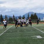 Barrows Dwight Unutoa prepares to pass the ball downfield to Ethan Goodwin, who will carry it to the Whalers first touchdown of the game on Saturday, Aug. 12, 2023 in Homer, Alaska (Delcenia Cosman/Homer News)