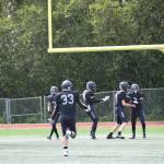 Chris Martishevs teammates congratulate him after he caught a 58-yard pass from quarterback Preston Stanislaw, scoring a touchdown and bringing the Mariners score up to eight points in the first quarter of the home opener varsity game on Saturday, Aug. 12, 2023 in Homer, Alaska. (Delcenia Cosman/Homer News)