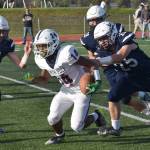 Soldotnas Collin Peck and Gehret Medcoff track down North Poles Devon Cooper-Jackson on Friday, Aug. 18, 2023, at Justin Maile Field at Soldotna High School in Soldotna, Alaska. (Photo by Jeff Helminiak/Peninsula Clarion)