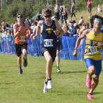 Homers Ethan Styvar sprints to the finish in the boyss varsity race at the Ted McKenney Invitational on Saturday, Aug. 19, 2023, at Tsalteshi Trails just outside of Soldotna, Alaska. (Photo by Jeff Helminiak/Peninsula Clarion)