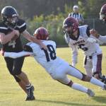 Nikiskis Oliver Parrish tries to shake the tackle of Eielsons Michael Garza on Saturday, Aug. 19, 2023, at Nikiski Middle-High School in Nikiski, Alaska. (Photo by Jeff Helminiak/Peninsula Clarion)