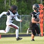 Eielsons Mitchell Drayton chases Nikiskis Kaiden Parrish on Saturday, Aug. 19, 2023, at Nikiski Middle-High School in Nikiski, Alaska. (Photo by Jeff Helminiak/Peninsula Clarion)