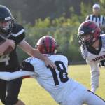 Nikiski's Cameron Parrish tries to shake the tackle of Eielson's Michael Garza on Saturday, Aug. 19, 2023, at Nikiski Middle-High School in Nikiski, Alaska. (Photo by Jeff Helminiak/Peninsula Clarion)