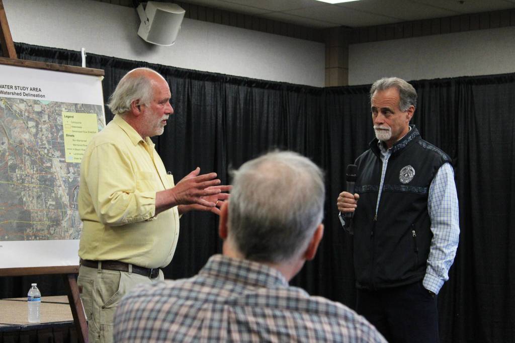 Dave Yragui, left, and Peter Micciche, right, talk about flood problems along Kalifornsky Beach Road during a public meeting on Thursday, Aug. 17, 2023, in Soldotna, Alaska. (Ashlyn OHara/Peninsula Clarion)