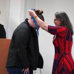 Morgan Gillman receives a certified nurse assistant pin from Ana Monyahan at a CNA graduation ceremony at Central Peninsula Hospital in Soldotna, Alaska, on Friday, Aug. 25, 2023. (Jake Dye/Peninsula Clarion)
