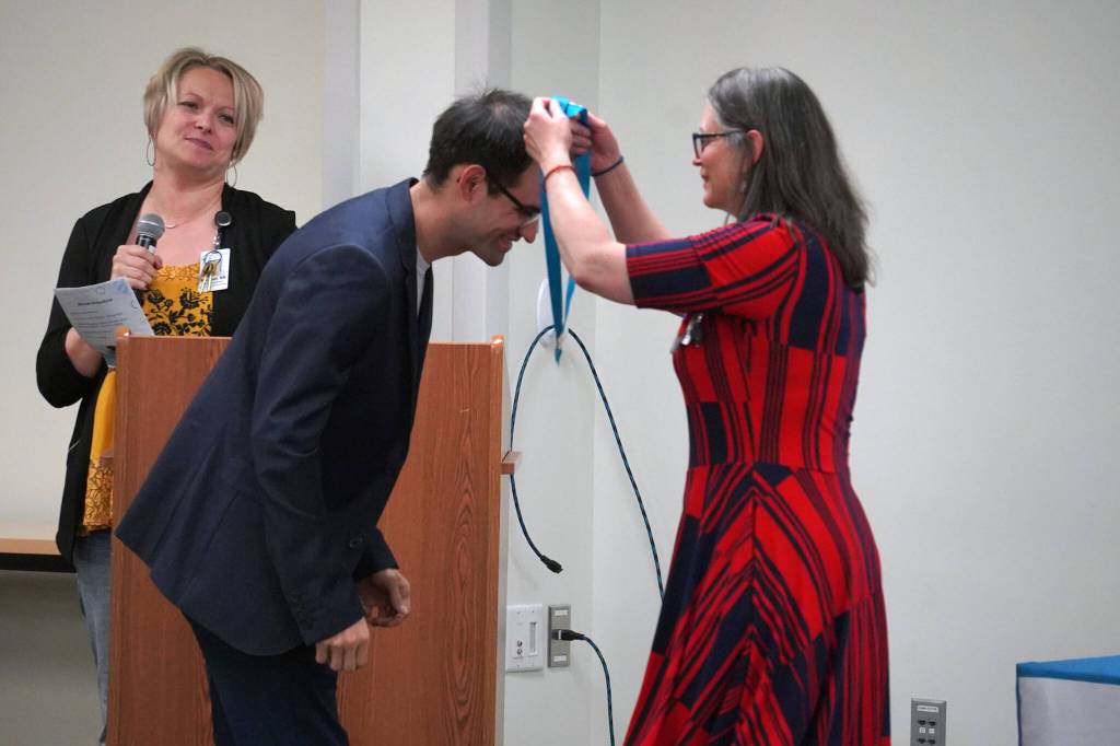 Ryan Kimball receives a certified nurse assistant pin from Ana Monyahan at a CNA graduation ceremony at Central Peninsula Hospital in Soldotna, Alaska, on Friday, Aug. 25, 2023. (Jake Dye/Peninsula Clarion)