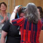 Jamie Childers receives a certified nurse assistant pin from Ana Monyahan at a CNA graduation ceremony at Central Peninsula Hospital in Soldotna, Alaska, on Friday, Aug. 25, 2023. (Jake Dye/Peninsula Clarion)