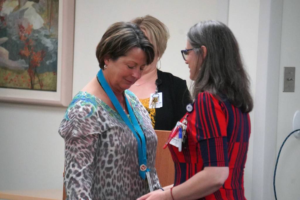 Deborah Merritt receives a certified nurse assistant pin from Ana Monyahan at a CNA graduation ceremony at Central Peninsula Hospital in Soldotna, Alaska, on Friday, Aug. 25, 2023. (Jake Dye/Peninsula Clarion)