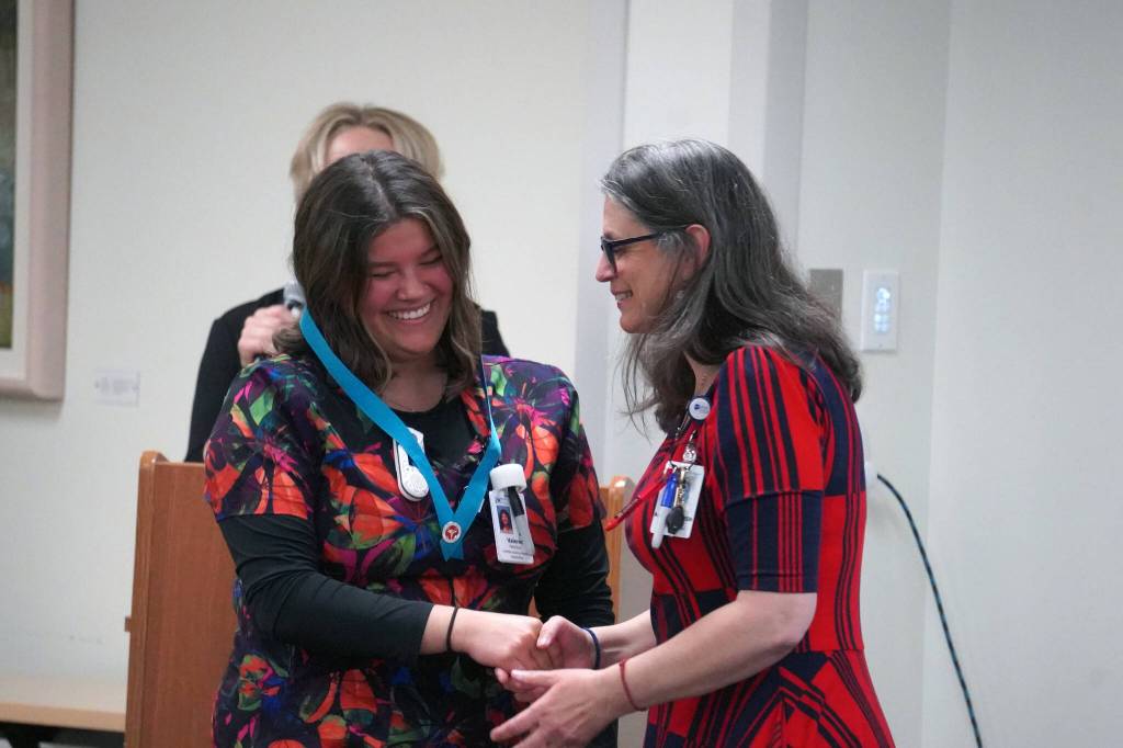 Valerie Villegas receives a certified nurse assistant pin from Ana Monyahan at a CNA graduation ceremony at Central Peninsula Hospital in Soldotna, Alaska, on Friday, Aug. 25, 2023. (Jake Dye/Peninsula Clarion)