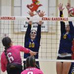 Homer's Alivia Fefelov and Goldie Hill put up a block against Kenai Central's Stella Selanoff on Tuesday, Aug. 29, 2023, at Kenai Central High School in Kenai, Alaska. (Photo by Jeff Helminiak/Peninsula Clarion)