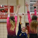 Homer's Channing Lowney attacks against Kenai Central's Avia Miller and Sophie Tapley on Tuesday, Aug. 29, 2023, at Kenai Central High School in Kenai, Alaska. (Photo by Jeff Helminiak/Peninsula Clarion)