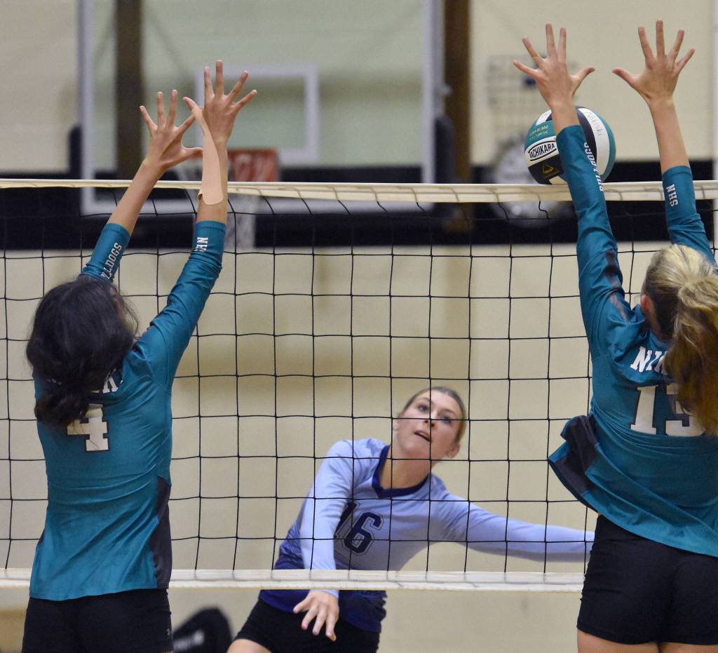 Soldotnas Abygale Schaeffer attacks against Nikiskis Alexa Iyatunguk and Mandee Roofe on Thursday, Aug. 31, 2023, at Nikiski Middle-High School in Nikiski, Alaska. (Photo by Jeff Helminiak/Peninsula Clarion)