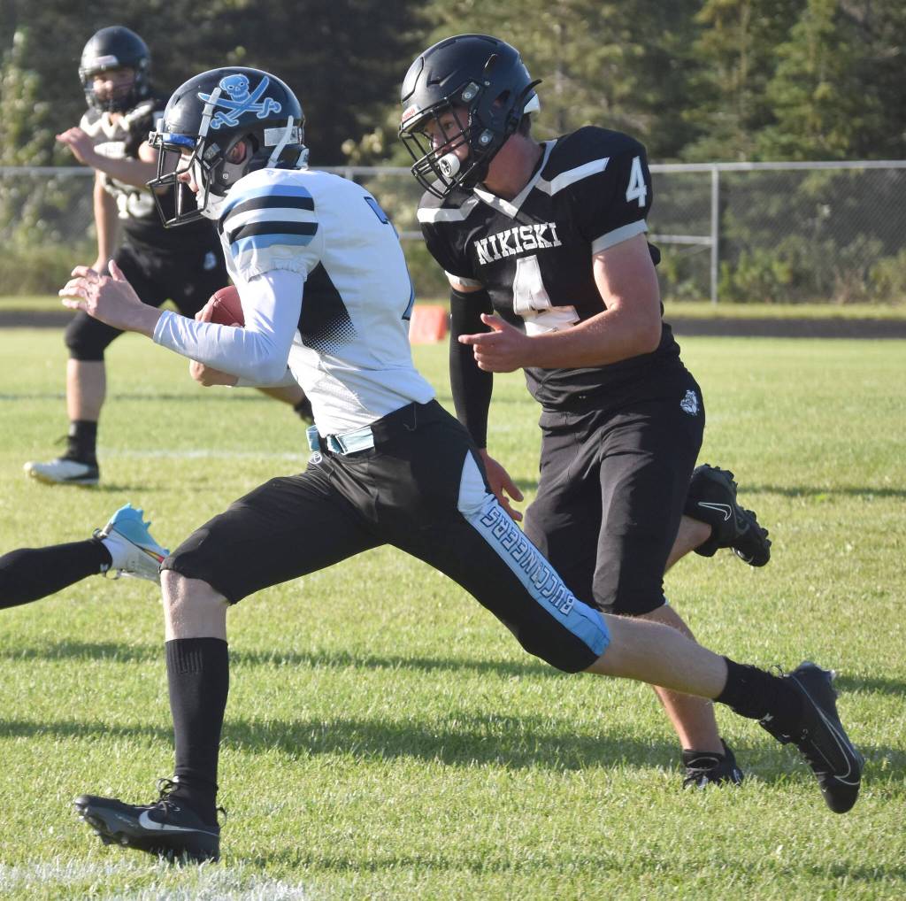 Nikiskis Oliver Parrish chases Valdez quarterback Barrett McCumby on Friday, Sept. 1, 2023, at Nikiski Middle-High School in Nikiski, Alaska. (Photo by Jeff Helminiak/Peninsula Clarion)