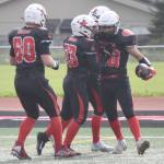 Kenai Centrals Bobby Hayes (far right) celebrates his touchdown run against Homer with teammates on Saturday, Sept. 2, 2023, at Ed Hollier Field at Kenai Central High School in Kenai, Alaska. (Photo by Jeff Helminiak/Peninsula Clarion)